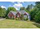 Charming brick home featuring manicured landscaping and a well-maintained lawn on a sunny day at 4530 Bogan Gates Dr, Buford, GA 30519