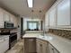 Modern kitchen features stainless steel appliances, a tiled backsplash, and ample counter space for meal preparation at 4530 Bogan Gates Dr, Buford, GA 30519