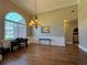 Bright living room boasts natural light from large windows, complementing hardwood floors and elegant chandelier at 4530 Bogan Gates Dr, Buford, GA 30519