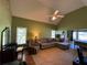 Expansive main bedroom with vaulted ceiling, hardwood floors, seating area, and large windows for natural light at 4530 Bogan Gates Dr, Buford, GA 30519
