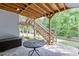 Covered patio area with stairs leading to the deck at 4530 Bogan Gates Dr, Buford, GA 30519