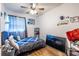 Comfortable bedroom featuring natural light, a ceiling fan, and wood laminate flooring at 110 Turman Se Ave, Atlanta, GA 30315