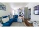 Open concept living room area with updated flooring, furnishings, paint and adjoined kitchen at 110 Turman Se Ave, Atlanta, GA 30315