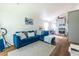 Sunlit living room with hardwood floors, an open floor plan, and a blue sectional sofa at 110 Turman Se Ave, Atlanta, GA 30315
