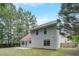 The home's backyard features a modest concrete patio, siding, double-hung windows, and a wood fence at 169 Parkside Dr, Stockbridge, GA 30281