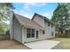View of the home's backyard featuring a concrete patio, siding, windows, and a door leading into the house at 169 Parkside Dr, Stockbridge, GA 30281