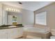 Bathroom featuring vanity with sink and a corner soaking tub at 169 Parkside Dr, Stockbridge, GA 30281