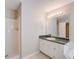 Bathroom featuring a walk-in shower, large mirror, and ample lighting at 169 Parkside Dr, Stockbridge, GA 30281