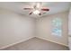 Carpeted bedroom featuring ceiling fan and natural light from window at 169 Parkside Dr, Stockbridge, GA 30281