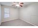 Carpeted bedroom with ceiling fan, window, and ample natural light at 169 Parkside Dr, Stockbridge, GA 30281