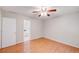 Bright bedroom features wood-look flooring and a ceiling fan, with ensuite bath access at 169 Parkside Dr, Stockbridge, GA 30281
