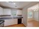 Functional kitchen boasts white cabinetry, modern appliances, and an open view into dining area at 169 Parkside Dr, Stockbridge, GA 30281