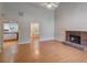 Open-concept living space with hardwood floors and brick fireplace at 169 Parkside Dr, Stockbridge, GA 30281
