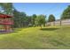 Spacious backyard featuring a lush green lawn, mature trees, and a deck perfect for outdoor entertaining at 3363 Linton Ln, Marietta, GA 30066