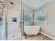 A modern bathroom features a glass enclosed shower and separate tub with lots of natural light at 3363 Linton Ln, Marietta, GA 30066