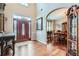 Elegant foyer featuring hardwood floors, a decorative front door, and an arched doorway leading to the dining room at 3363 Linton Ln, Marietta, GA 30066