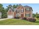 Charming two-story brick home featuring an attached garage, landscaped front yard, and a welcoming red front door at 3363 Linton Ln, Marietta, GA 30066