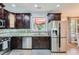 Modern kitchen with stainless steel appliances, granite countertops, and dark wood cabinets at 3363 Linton Ln, Marietta, GA 30066