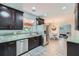 Well-lit kitchen with stainless steel appliances, granite countertops, and dark cabinets, offering a modern and functional space at 3363 Linton Ln, Marietta, GA 30066