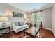 Cozy living room with hardwood floors, neutral paint, and stylish curtains framing the window, and a modern glass coffee table at 3363 Linton Ln, Marietta, GA 30066