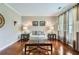 Cozy living room with hardwood floors, neutral paint, and stylish curtains framing the window, and a modern glass coffee table at 3363 Linton Ln, Marietta, GA 30066