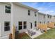 A patio with seating is nestled in the backyard of this house with light gray siding and views from multiple windows at 340 Navigator Ln, Mcdonough, GA 30253