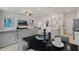 Open concept living and dining area with modern decor, neutral tones and stainless steel appliances at 340 Navigator Ln, Mcdonough, GA 30253