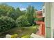 Two story back deck overlooking a private, wooded backyard with mature trees and a brick walkway at 3537 Castle View Ct, Suwanee, GA 30024