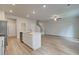 Spacious living room with wood flooring open to the kitchen area at 360 Navigator Ln, Mcdonough, GA 30253