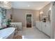 Spacious primary bathroom features double vanity, a luxurious soaking tub, and marble tile flooring at 3695 Highway 140, Rydal, GA 30171