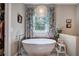 Bathroom with stand-alone tub, walk in closet, and bright window at 3695 Highway 140, Rydal, GA 30171