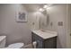 Modest bathroom features a gray vanity with a white countertop and a framed floral print at 3695 Highway 140, Rydal, GA 30171
