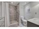 Modern bathroom featuring a tiled shower with glass door, toilet and vanity at 3695 Highway 140, Rydal, GA 30171