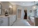 Bright bathroom features double sinks, soaking tub, stand-up shower, and walk-in closet at 3695 Highway 140, Rydal, GA 30171