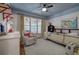 Bright bedroom with a large window, cozy chair, and fun decor on the walls at 3695 Highway 140, Rydal, GA 30171