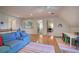 Bonus room with hardwood floors, couch, and access to a bedroom and office, offering versatile living space at 3695 Highway 140, Rydal, GA 30171