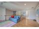 Upstairs bonus room featuring hardwood floors, a comfortable couch, and a doorway to the bathroom at 3695 Highway 140, Rydal, GA 30171