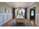 Formal dining area with modern light fixture, hardwood floors, and beautiful wainscoting at 3695 Highway 140, Rydal, GA 30171