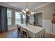 Bright dining room featuring large windows with exterior view and modern chandelier at 3695 Highway 140, Rydal, GA 30171