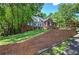 Stately brick home with a long brick wall, lush lawn, and mature trees at 3695 Highway 140, Rydal, GA 30171