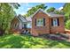 Attractive brick home featuring multiple windows, a well-maintained yard, and a charming entrance at 3695 Highway 140, Rydal, GA 30171