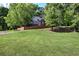 Charming brick home with mature trees, a manicured lawn, and a classic architectural design at 3695 Highway 140, Rydal, GA 30171