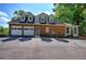 Home exterior with two-car garage and dormer windows at 3695 Highway 140, Rydal, GA 30171
