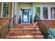 Inviting front entrance with decorative wreath and potted plants on brick steps at 3695 Highway 140, Rydal, GA 30171