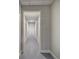 Hallway with neutral walls and a light gray floor leads to a bright white door at 3695 Highway 140, Rydal, GA 30171