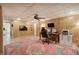 Home office in basement features wood paneling, ceiling fan and large rug at 3695 Highway 140, Rydal, GA 30171