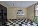 Kitchen nook with black and white checkerboard floors and barstool seating at 3695 Highway 140, Rydal, GA 30171