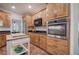 Well-equipped kitchen featuring modern appliances, and plenty of wood cabinets at 3695 Highway 140, Rydal, GA 30171