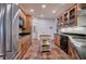 Functional kitchen with brick flooring, wood cabinetry, and modern stainless appliances at 3695 Highway 140, Rydal, GA 30171