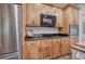 Bright kitchen showcases stainless steel refrigerator, built-in oven and microwave, and custom wood cabinets at 3695 Highway 140, Rydal, GA 30171